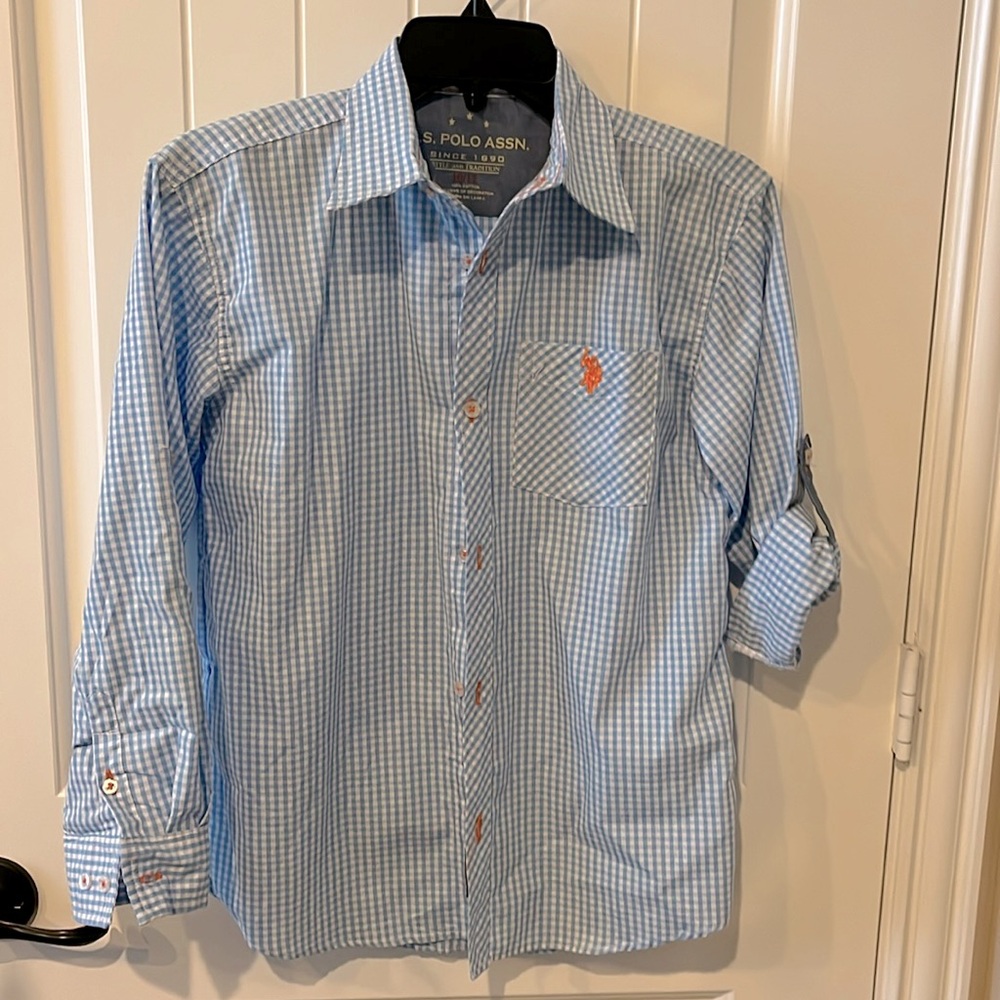 Has Polo Assn button down shirt